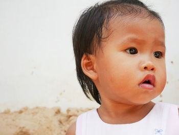 Close-up portrait of cute baby looking away