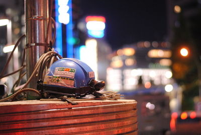 Close-up of illuminated lighting equipment on street at night