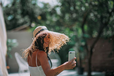 Midsection of man using mobile phone outdoors