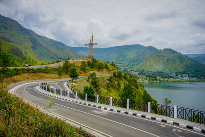 Road by mountain against sky