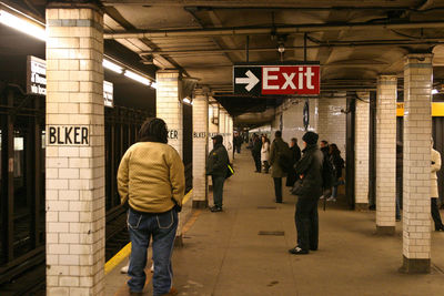 Rear view of people walking in subway station