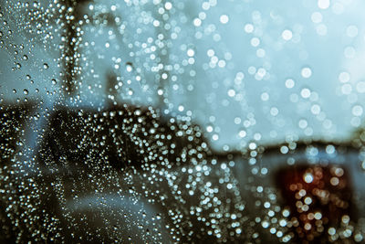 Close-up of wet glass window in rainy season