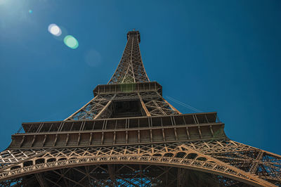 Bottom view of art nouveau style eiffel tower and sunlight in paris. the famous capital of france.