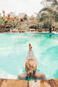 Rear view of woman swimming in pool