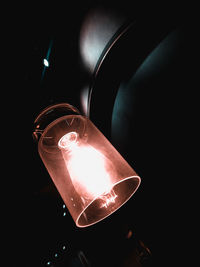 Close-up of illuminated light bulb in darkroom