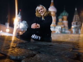 Woman sitting on a man holding illuminated candles