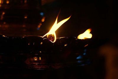 Close-up of fire in dark room