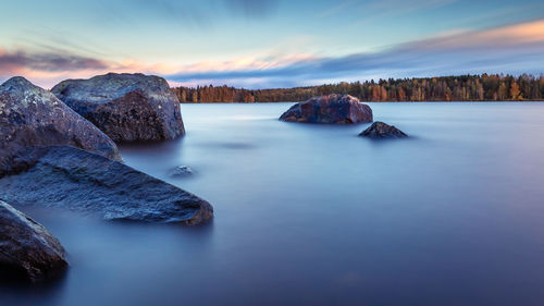 Scenic view of rock formation in lake against sky