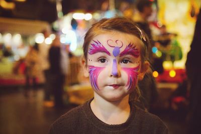 Girl with face paint during carnival at night
