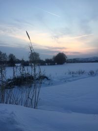 Scenic view of snow covered landscape against sky