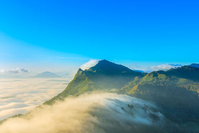 Scenic view of mountains against blue sky
