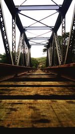 Low angle view of footbridge against sky