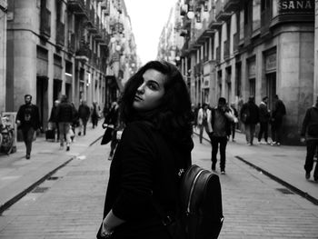 Portrait of young woman on city street