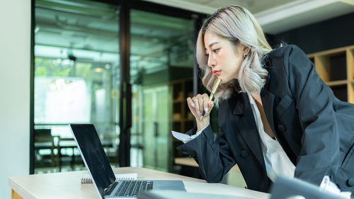 Beautiful freelancer asian woman working online at home office, happiness young asian woman working.