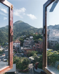 High angle view of buildings and mountains against sky