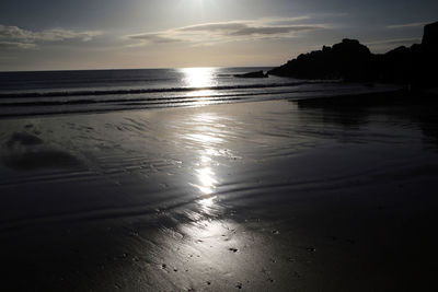 Scenic view of beach against sky during sunset