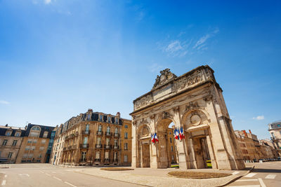 Low angle view of historical building against blue sky