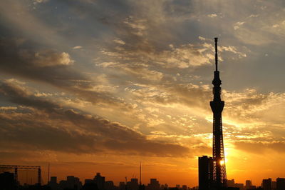 Silhouette of communications tower at sunset