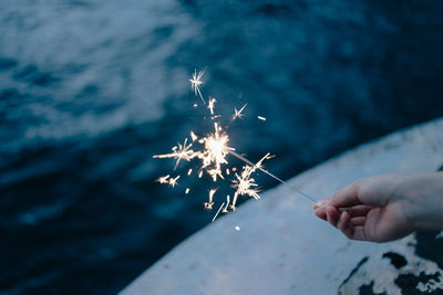 Close-up of hand holding sparkler