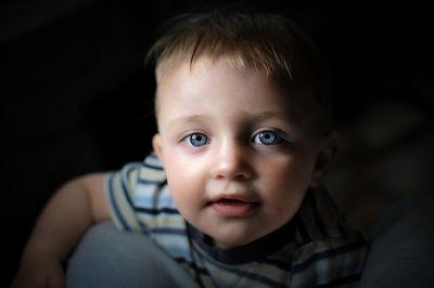 High angle portrait of baby boy in darkroom