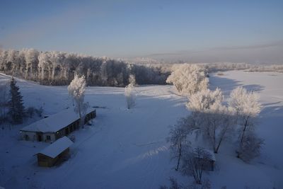 High angle view of houses and trees covered with snow