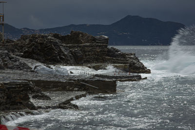 Scenic view of sea against mountain range