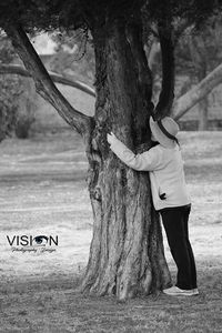 Rear view of man standing on tree trunk