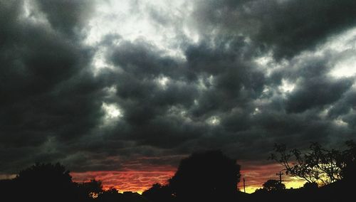 Low angle view of storm clouds at sunset
