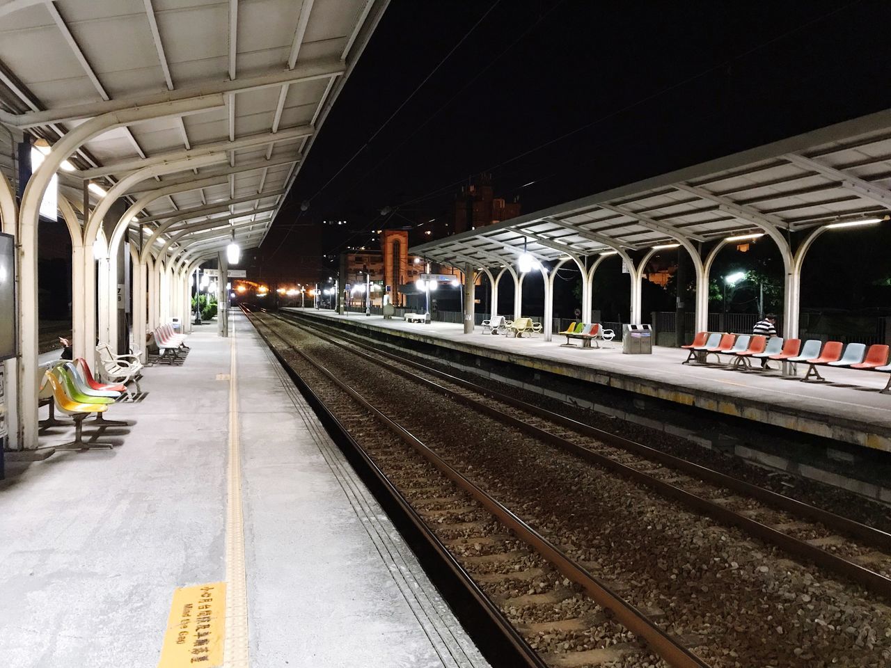 TRAIN AT RAILROAD STATION PLATFORM AT NIGHT