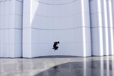 Man jumping in modern building