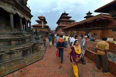 People at temple against sky