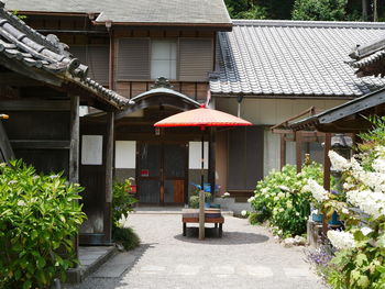 Houses by footpath against buildings