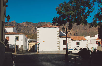 Houses in town against clear blue sky