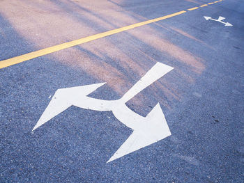 High angle view of arrow sign on road