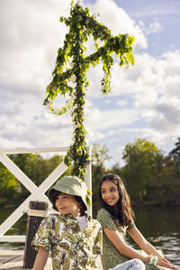 Children sitting under midsummer maypole