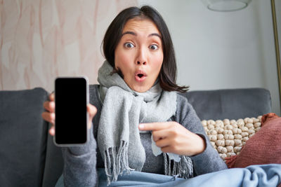 Portrait of young woman using mobile phone