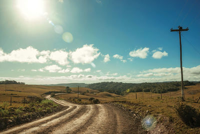 Deserted dirt road passing through rural lowlands with sunlight near cambará do sul. brazil.