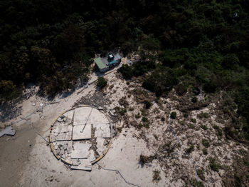 High angle view of abandoned car on road amidst trees