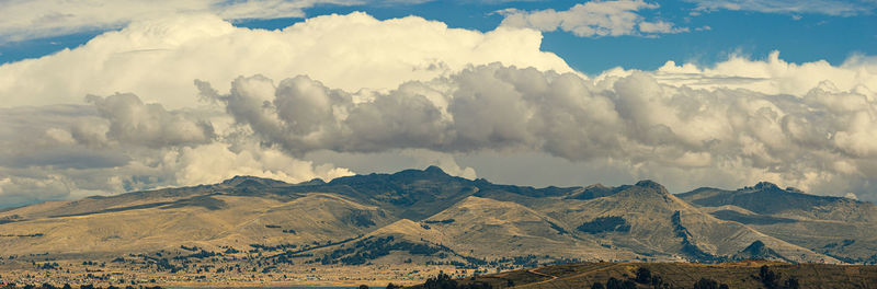 Panoramic view of mountains against cloudy sky
