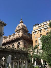 Low angle view of historic building against clear blue sky