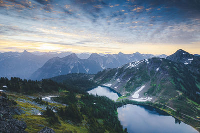 Scenic view of snowcapped mountains against sky during sunset