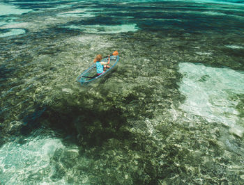 High angle view of people swimming in sea