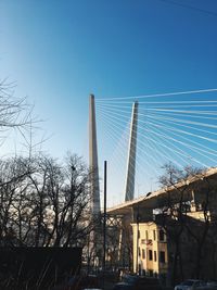 Low angle view of suspension bridge against sky