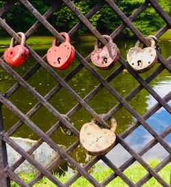 Close-up of padlocks on metal fence