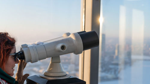 Coin-operated binoculars against sky