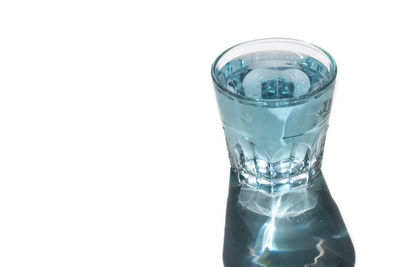 Close-up of water glass against white background