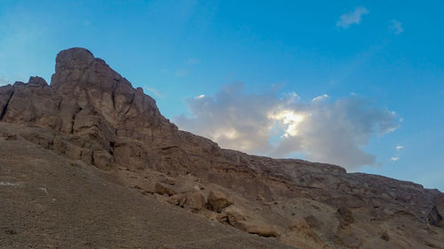 Low angle view of rock formations against sky