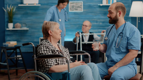 Doctor talking with patient at rehab center