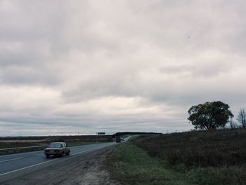 Cars on road against sky