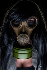 Close-up of portrait of woman wearing gas mask